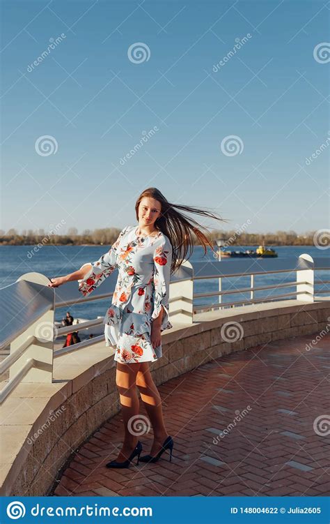 Dynamic Fashion Style Portrait Of A Young Beautiful Girl Walking Along