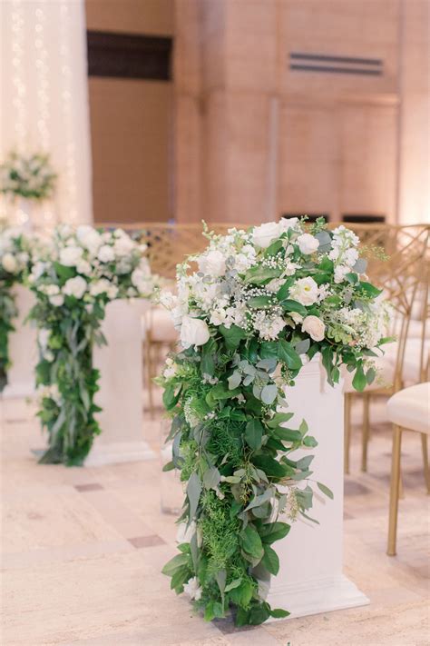 Cascading Greenery And White Flower Aisle Arrangements Wedding Aisle Decorations White Flower