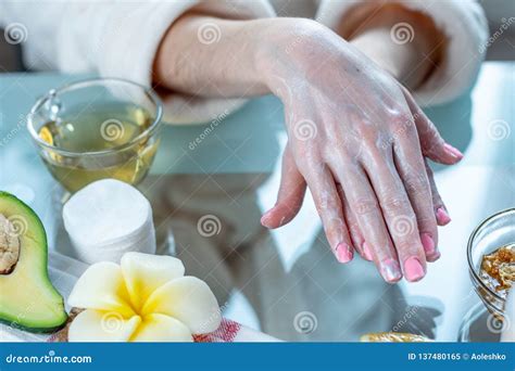 Woman Applying The Cream On Hands Nourishing Them With Natural