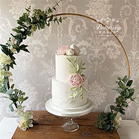 Elegant Rustic Wedding Cake With Pretty Flowers Displayed In A Rustic