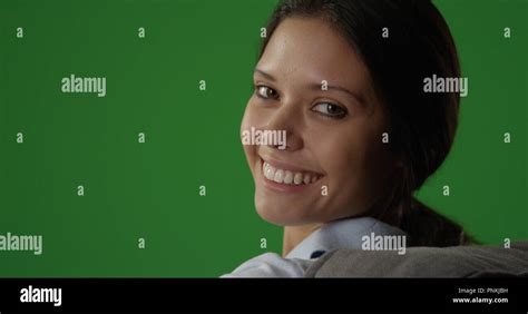Pretty Brunette Woman Looking Back And Smiling At Camera On Greenscreen