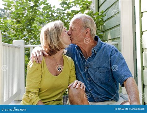 Retired Couple Sitting On Porch And Kissing Stock Image Image Of Kissing Hugging 26660445
