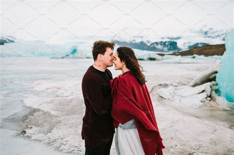 Groom Tenderly Kissing Her Beautiful Bride In Nose Cheerful Newlyweds Is Hugging In Glacier