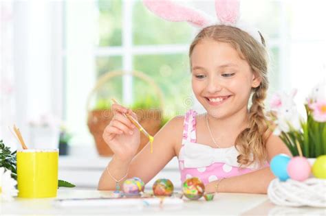Portrait Of Beautiful Girl Painting Eggs For Easter Holiday Stock Image