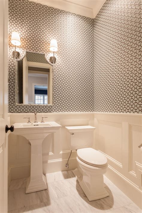 Geometric Wallpapered Powder Room With White Wainscoting And Tile