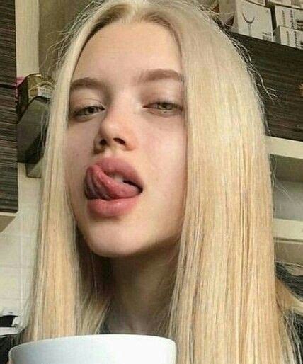 Woman With Long Blonde Hair Sticking Her Tongue Out
