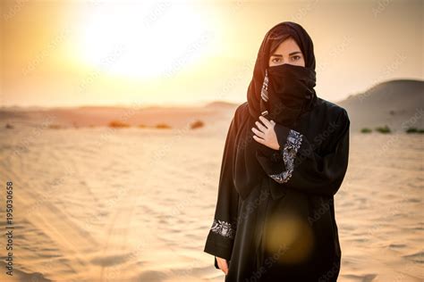 Portrait Of Beautiful Arab Woman In The Desert During Sunset Stock