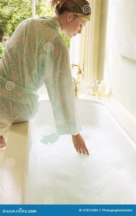 Woman Testing Water In Bathtub Filled With Bubbles Stock Photo Image Of Leisure Calm