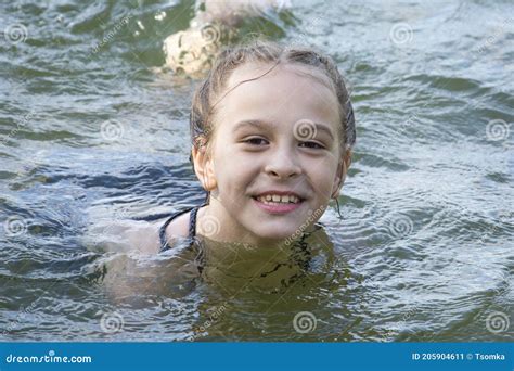 In The Summer A Girl In A Swimsuit Bathes On The Lake Stock Image