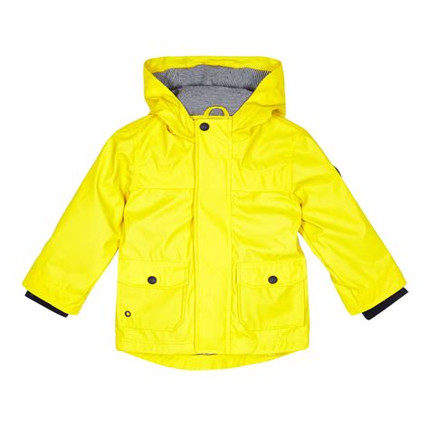 A child in a yellow raincoat stands next to a large flowering spirea bush, holding and sniffing white flowers, enjoying the aroma. J By Jasper Conran Kids Boys' Yellow Raincoat From ...