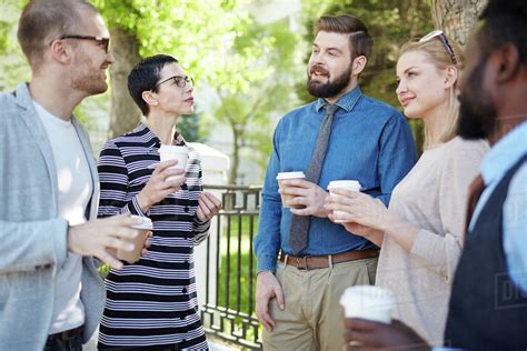 Group Of People With Drinks Talking Outside Stock Photo Dissolve
