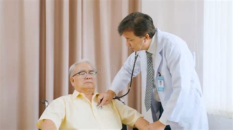 Asian Senior Patient Having Medical Exam With Doctor In Hospital Stock