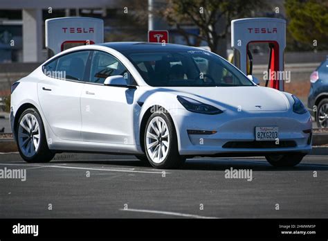 A Tesla Model 3 Car Is Seen Charging At Tesla Super Chargers Near The