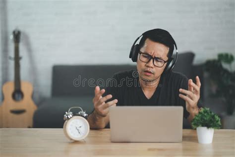 Asian Freelance Man Wearing Headphone Having Stressful Depression Sad