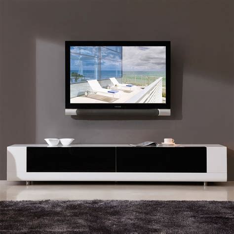 A Flat Screen Tv Mounted To The Side Of A White Entertainment Center In A Living Room