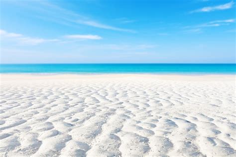 Premium Photo White Sand Curve Or Tropical Sandy Beach With Blurry Blue Ocean And Blue Sky