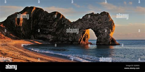 Durdle Door A Natural Limestone Arch At Sunset Along The Jurassic
