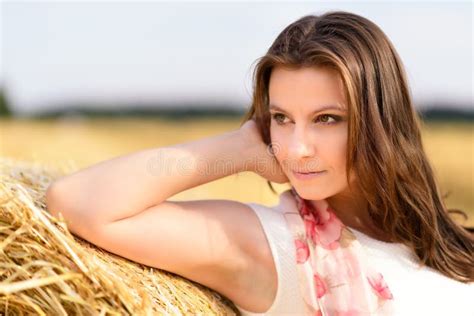 Young Caucasian Woman Long Brown Hair Leaning Against Bale Straw Stock