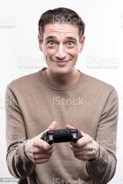 Pleasant Man Playing Video Games With Controller Stock Photo Download