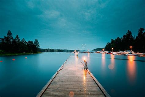 Sweden Beautiful Wooden Pier Near Lake In Summer Evening Night Stock