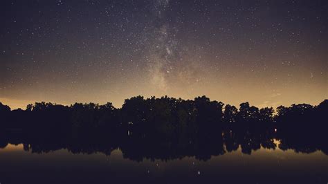 Silhouette Of Trees Near Body Of Water Milky Way Stars Water Nature