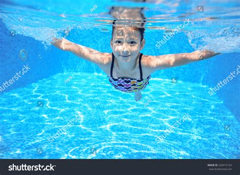 Happy Active Underwater Child Swims In Pool Beautiful Healthy Girl