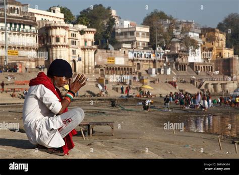 pilgrims praying in the early morning at reewa ghat on the banks of river ganges at varanasi in