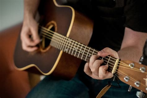 Person Playing Brown Guitar · Free Stock Photo