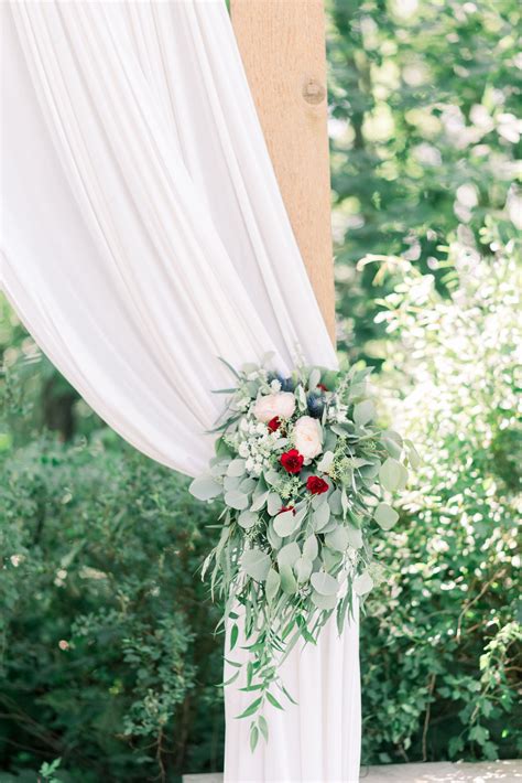 Wood Wedding Arbor With White Draped Fabric And Greenery Outdoor