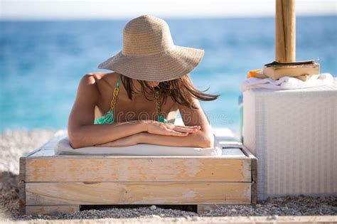 Beautiful Woman Sunbathing In A Bikini On A Beach At Tropical Travel