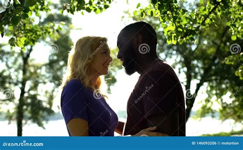 Cheerful Mixed Race Couple Looking At Each Other With Love Happy To Be