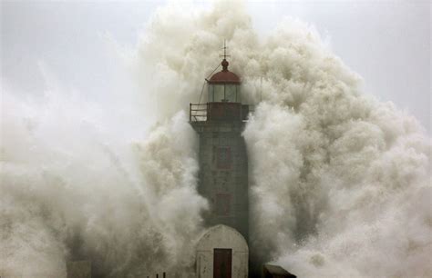 Meancutie A Wave Crashes Into A Lighthouse In Porto Portugal Giant