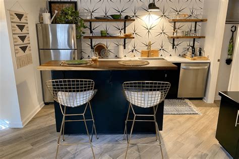 Two Stools Sit In Front Of A Kitchen Island