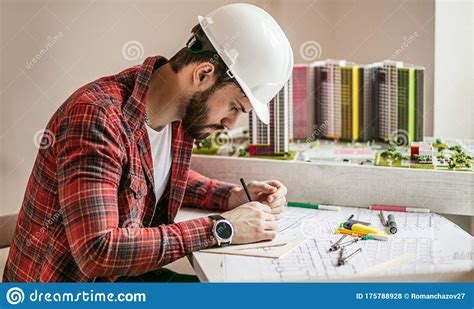 Young Architect Working With Blueprints In Office Stock Photo Image