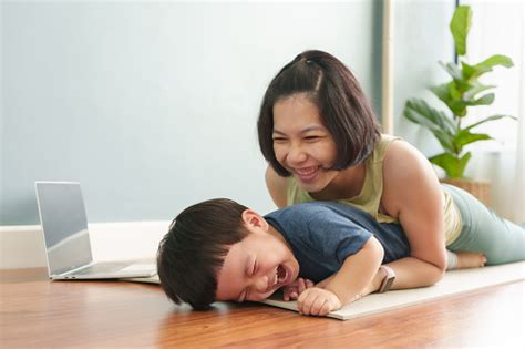 Asian Japanese Mother Playing And Hugging Her Adorable Son On Floor