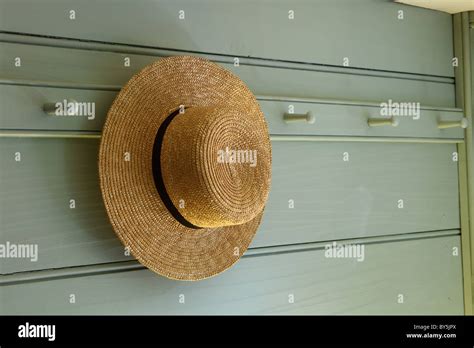 A Straw Hat Hanging On A Peg In A Reproduction Colonial Style House