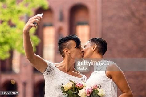 Lesbian Couple Taking Selfie From Mobile Phone While Kissing Photo