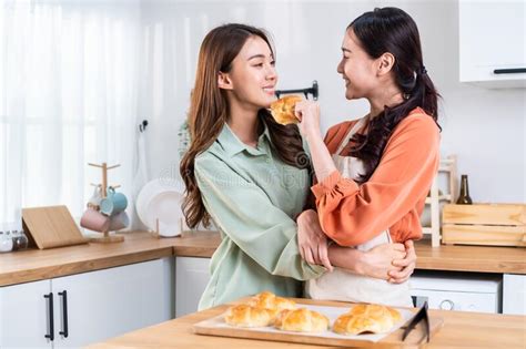 Asian Beautiful Lesbian Woman Couple Look At Girlfriend Bake Croissant