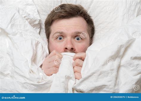 Nightmare Caucasian Man Is Scared He Hides Under The Covers And Looks