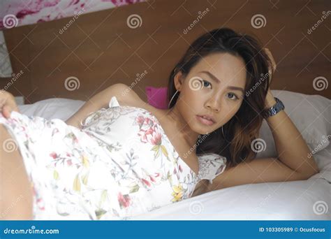 Young Attractive And Beautiful Asian Woman Lying On Bed At Bedroom Posing In Beauty Indoors
