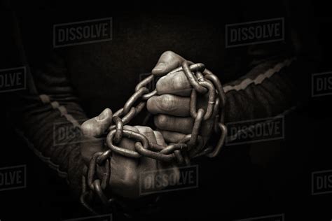 Close Up Of Hands Trying To Break Chains Stock Photo Dissolve