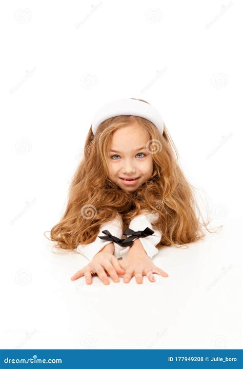 Girl With Long Hair Dressed In White Clothes Lies On The Floor Stock