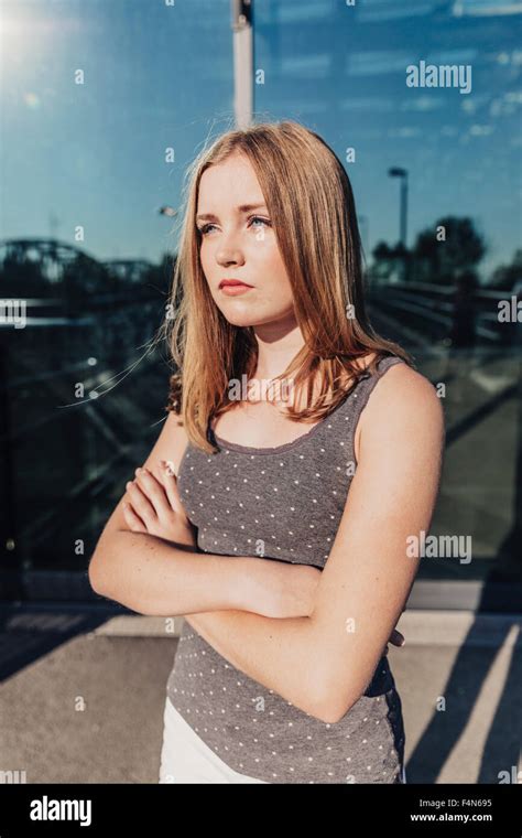Teenage Girl With Folded Arms Outdoors Stock Photo Alamy