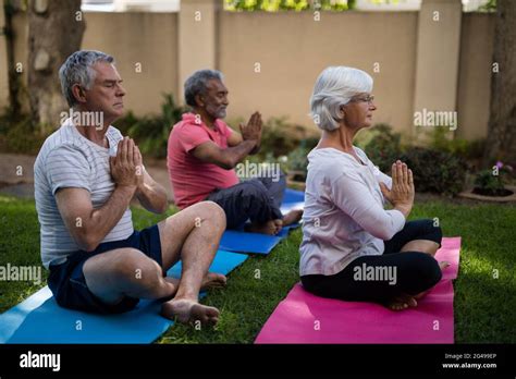 Senior People Meditating In Prayer Position Stock Photo Alamy