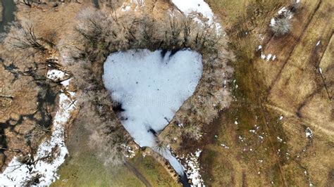 Aerial Drone Shot Of Frozen Lake With Heart Shape In Bavaria Stock
