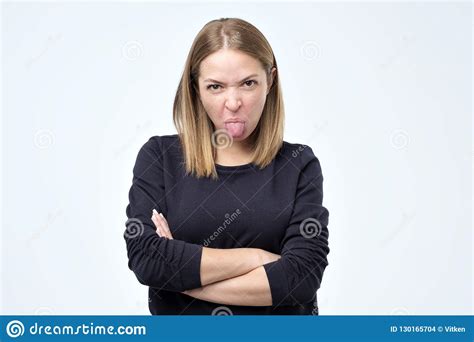 Dissatisfied Woman Frowns Face Has Disgusting Expression Shows Tongue