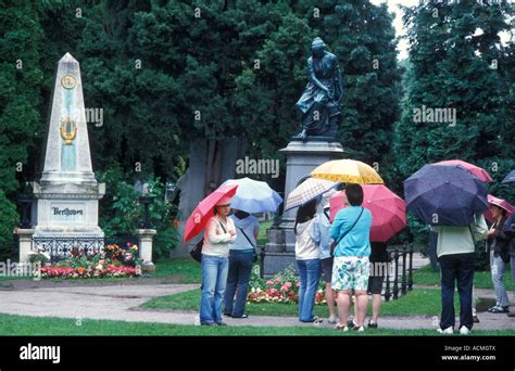 Tourists At The Famous Graves Of Zentralfriedhof Cemetery In Vienna