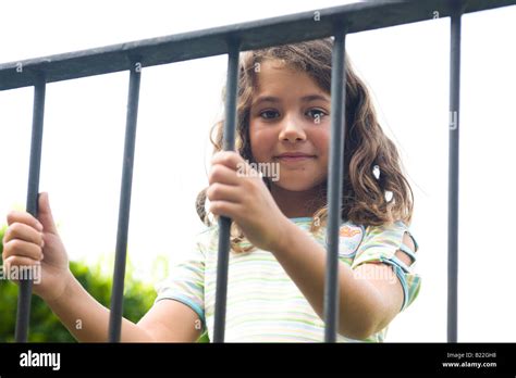 Beautiful child behind bars Stock Photo - Alamy