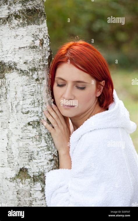 Woman Leaning Against A Tree Stock Photo Alamy