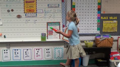 This teacher took the rolling chair away from her desk and put it to better use here. Calendar Morning Meeting 1st Grade - YouTube